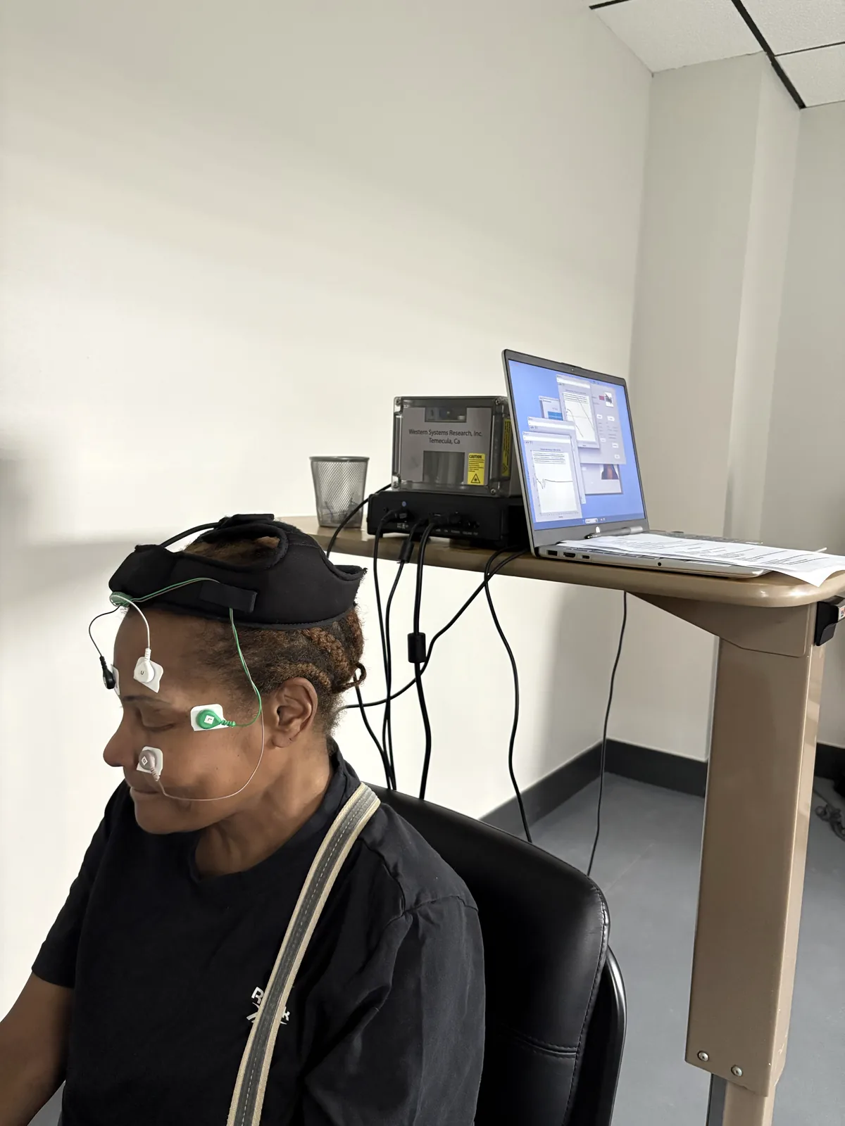 Patient seated for VNG balance testing with recording sensors in place at Regenerve, 4477 Woodson Rd #104, St. Louis, MO 63134